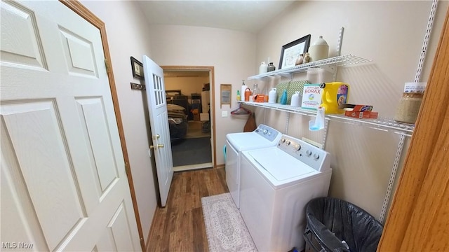 laundry room featuring washer and clothes dryer and hardwood / wood-style floors