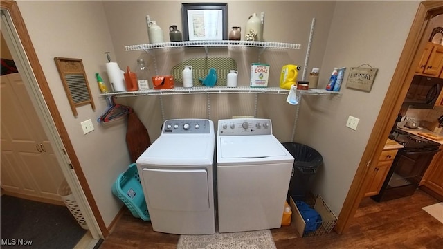 washroom with washer and dryer and dark hardwood / wood-style flooring