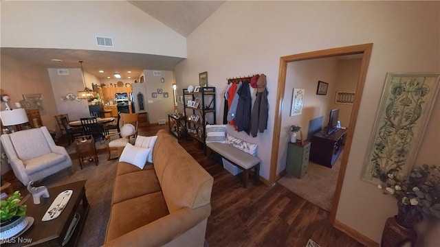 living room featuring dark wood-type flooring and high vaulted ceiling