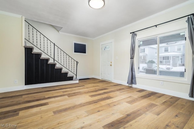 foyer entrance featuring crown molding and wood-type flooring