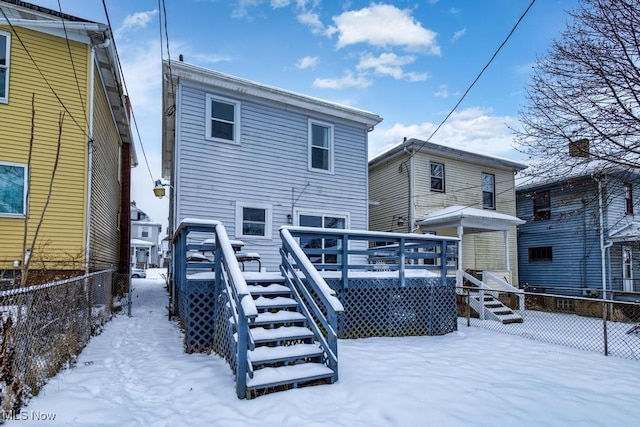 snow covered property featuring a wooden deck