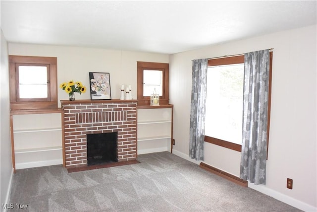 living room with carpet and a fireplace