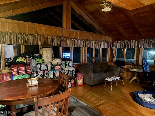 dining room featuring hardwood / wood-style flooring, lofted ceiling with beams, and wooden ceiling