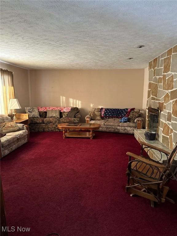 living room featuring carpet and a textured ceiling