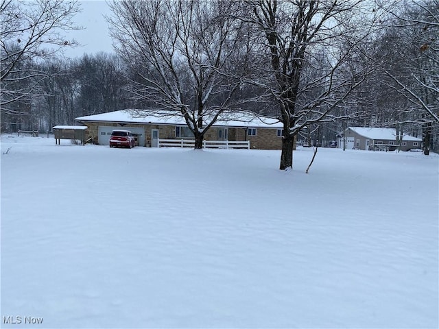 yard covered in snow with a garage