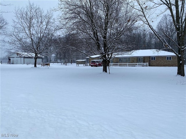 view of yard layered in snow