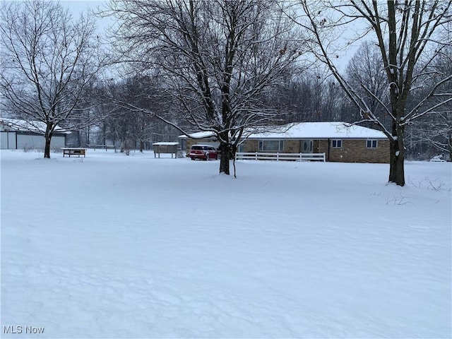 view of yard layered in snow