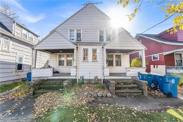 rear view of property featuring covered porch