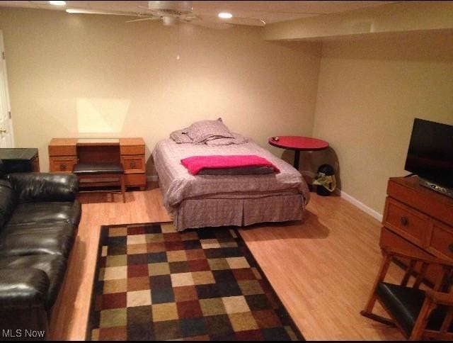 bedroom with hardwood / wood-style floors and ceiling fan