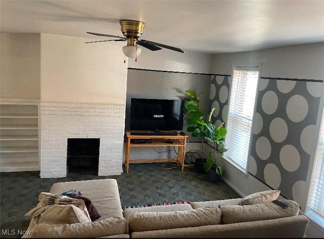 carpeted living room with ceiling fan and a brick fireplace