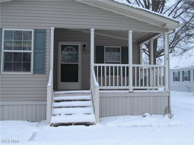 view of snow covered property entrance