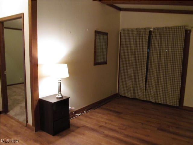 empty room with baseboards and wood finished floors