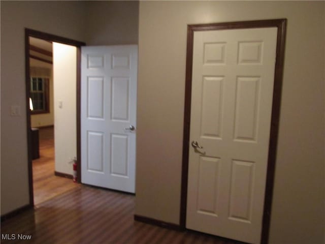 interior space with dark wood finished floors and baseboards