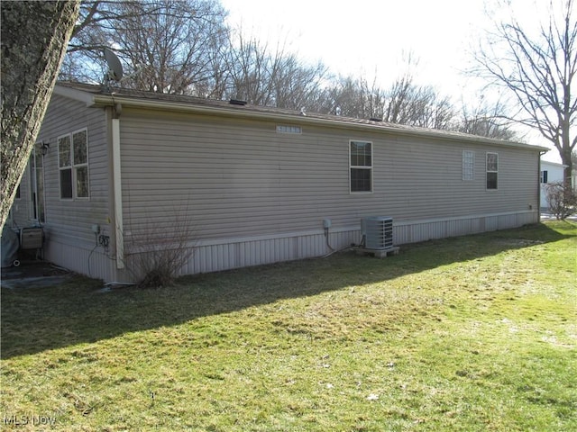 view of home's exterior featuring a yard and cooling unit