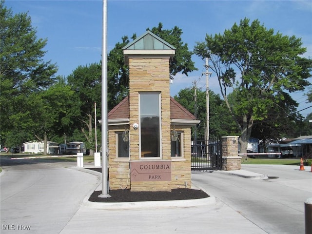 community sign featuring a gate