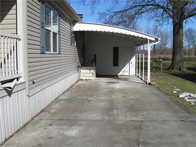 view of property exterior with driveway and a carport