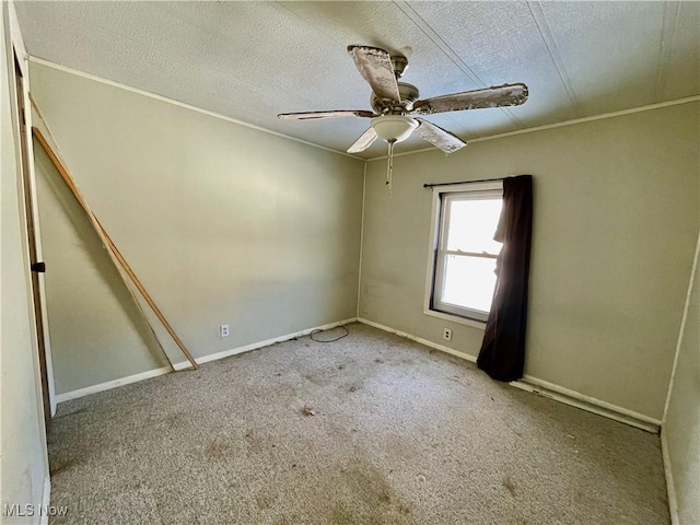 unfurnished room with a textured ceiling, ceiling fan, and light carpet