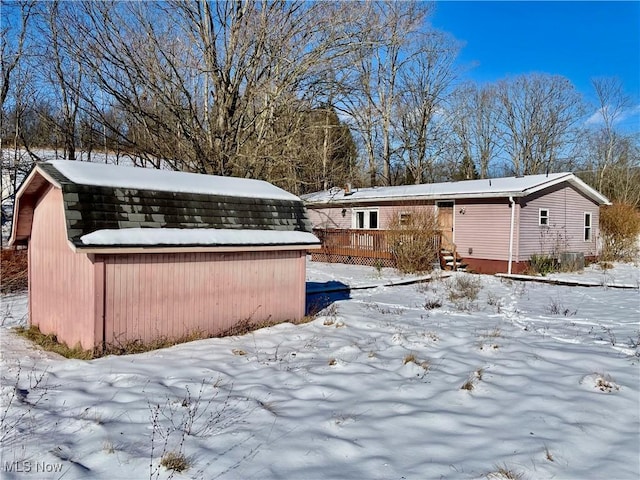 snowy yard featuring a deck