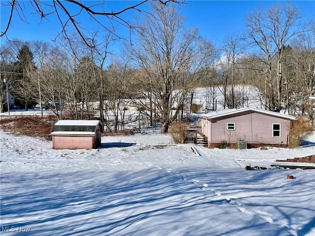 yard covered in snow with cooling unit