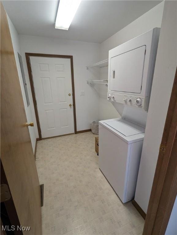 laundry room with stacked washer / drying machine