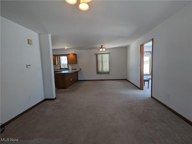 unfurnished living room with light colored carpet