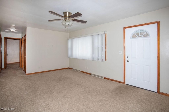 carpeted entryway featuring ceiling fan