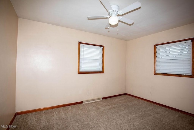 carpeted spare room featuring ceiling fan