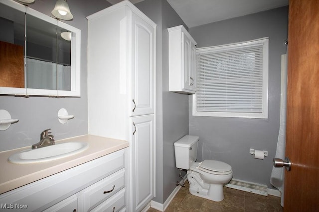 bathroom with tile patterned flooring, vanity, and toilet