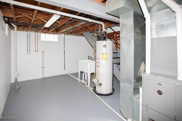 basement with heating unit, sink, and gas water heater