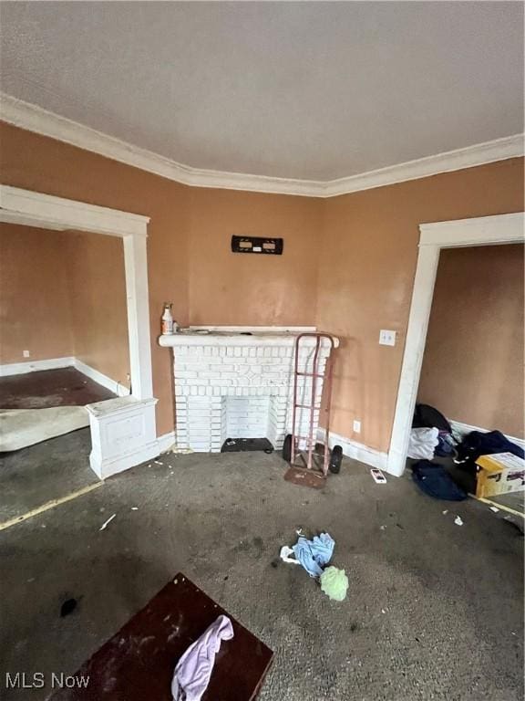 unfurnished living room featuring a fireplace and crown molding