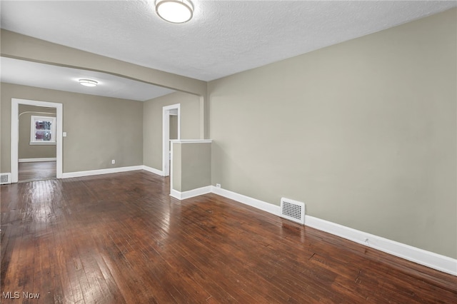 spare room featuring hardwood / wood-style floors and a textured ceiling