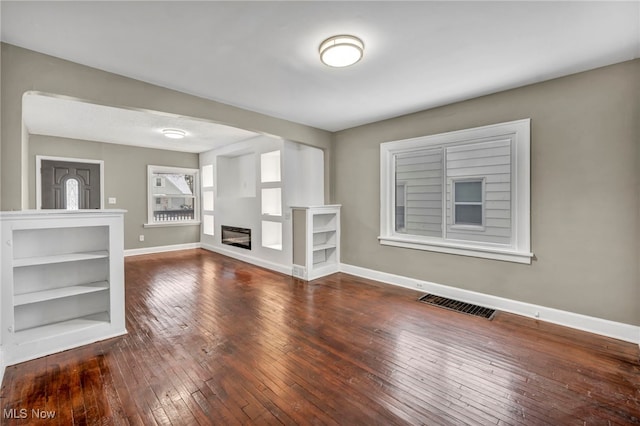 unfurnished living room with hardwood / wood-style flooring