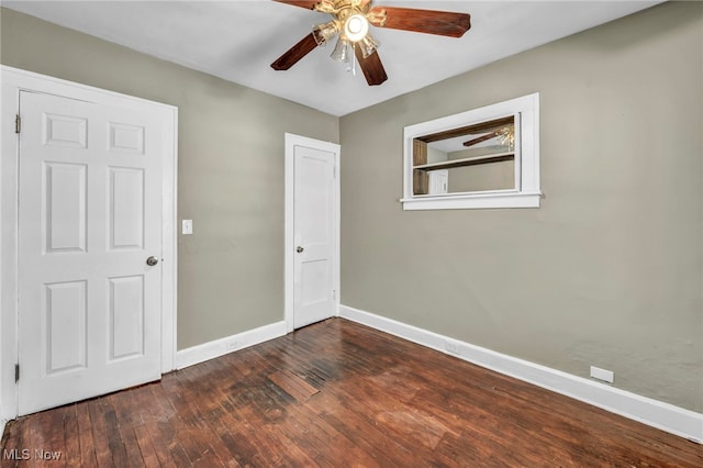 empty room featuring dark hardwood / wood-style floors and ceiling fan