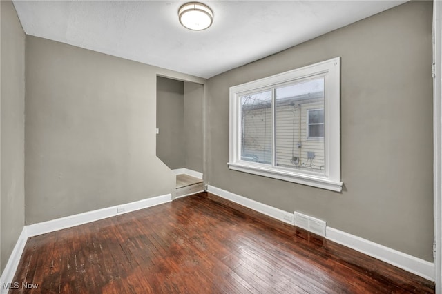 unfurnished room featuring dark hardwood / wood-style floors