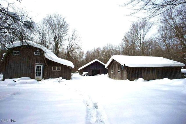 view of snow covered exterior featuring an outdoor structure