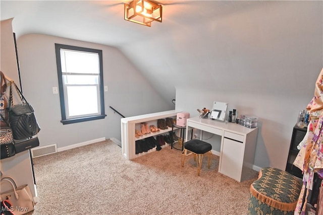 office space with light carpet and lofted ceiling