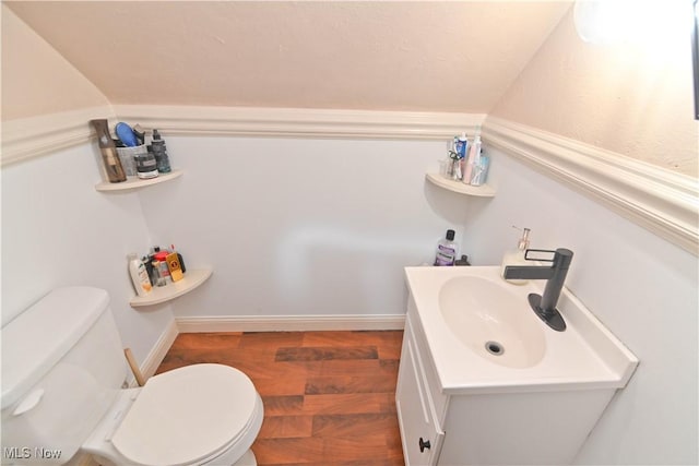 bathroom featuring hardwood / wood-style floors, vanity, and toilet