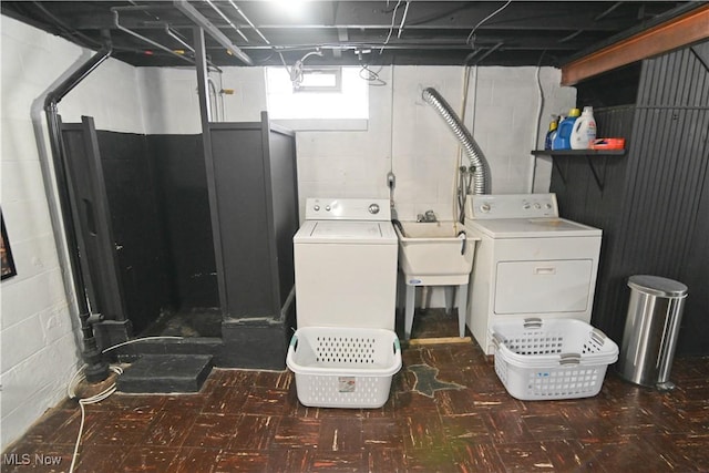 laundry room with separate washer and dryer and sink