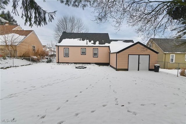 view of snow covered rear of property