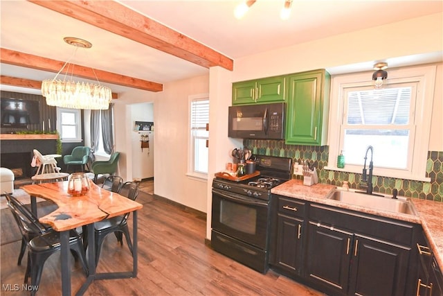 kitchen featuring beam ceiling, light stone countertops, sink, hanging light fixtures, and black appliances