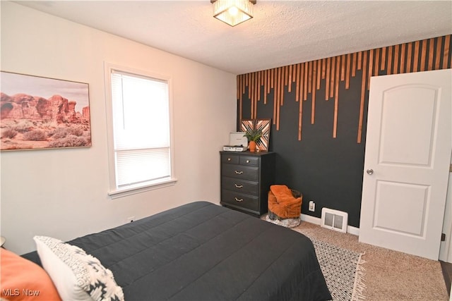 bedroom featuring carpet floors and a textured ceiling