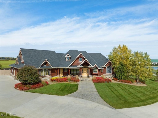 craftsman-style house with a front yard