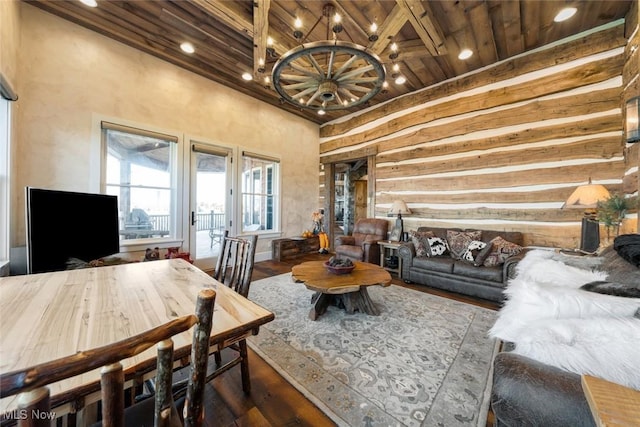 living room featuring beamed ceiling, hardwood / wood-style flooring, an inviting chandelier, and wood ceiling