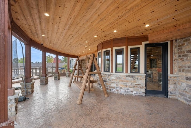 unfurnished sunroom featuring wood ceiling