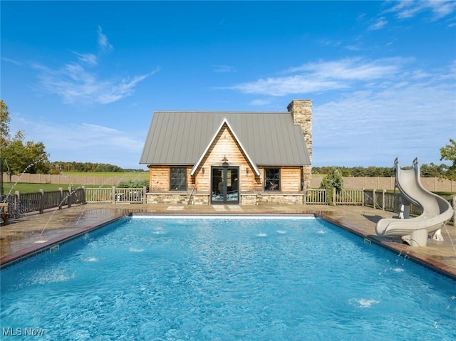 view of pool with pool water feature, a patio, and a water slide