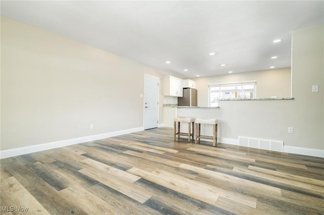 unfurnished living room featuring wood-type flooring