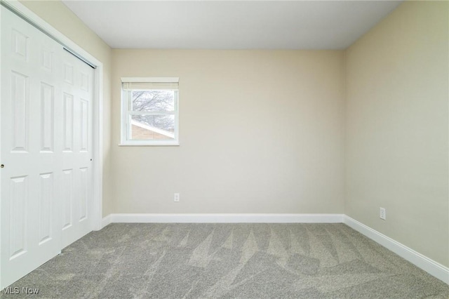 unfurnished bedroom with carpet flooring and a closet