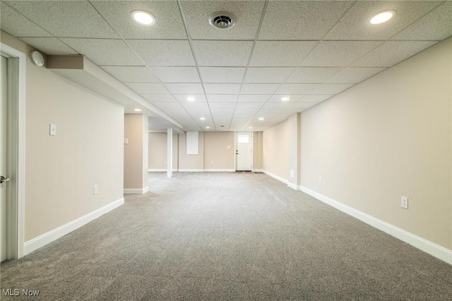 basement featuring carpet and a drop ceiling