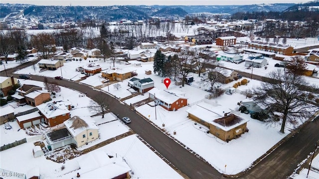 snowy aerial view with a mountain view