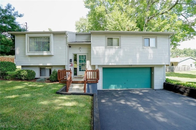 raised ranch with a front lawn and a garage